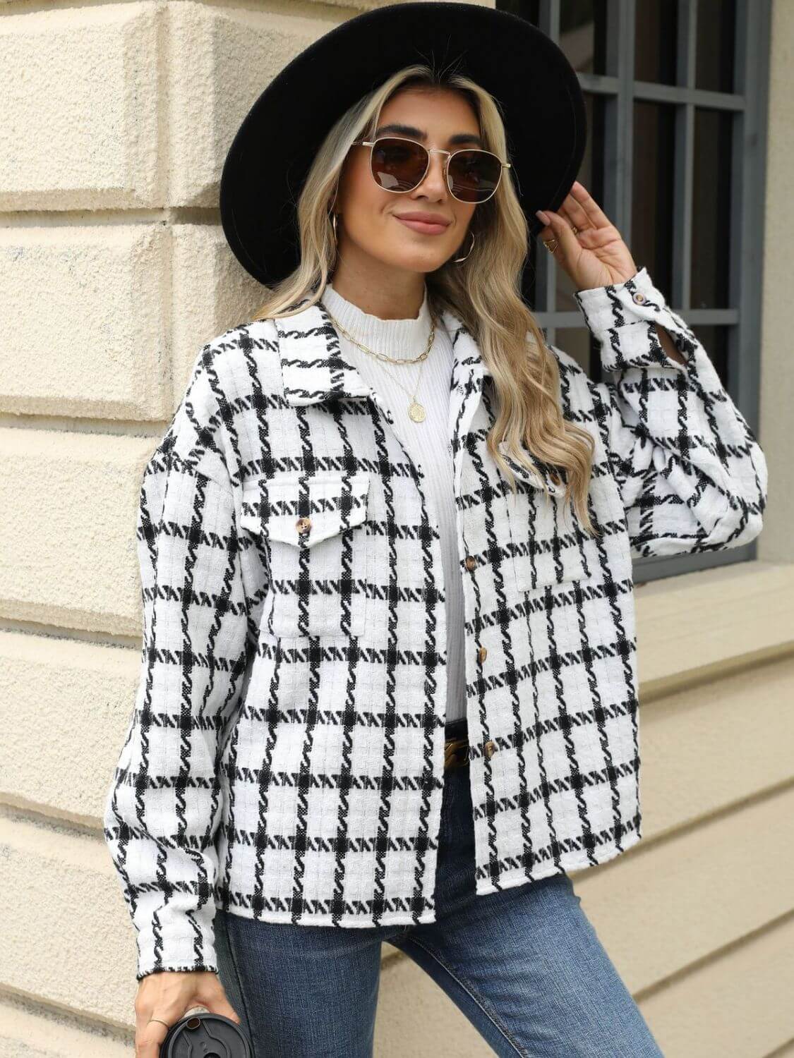 Woman wearing Bella Road Plaid Collared Neck Long Sleeve Jacket with sunglasses and black hat outside a building.