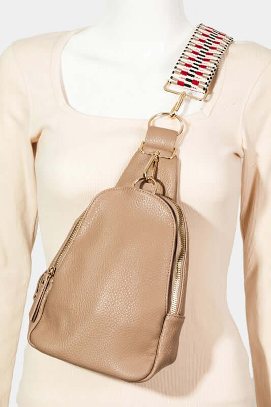 Stylish medium faux leather sling bag in beige with a colorful strap, perfect for everyday use.