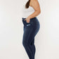 Model wearing Cat's Whiskers Raw Hem High Waist Jeans, showcasing the side view with raw hem detailing and a high waist fit.