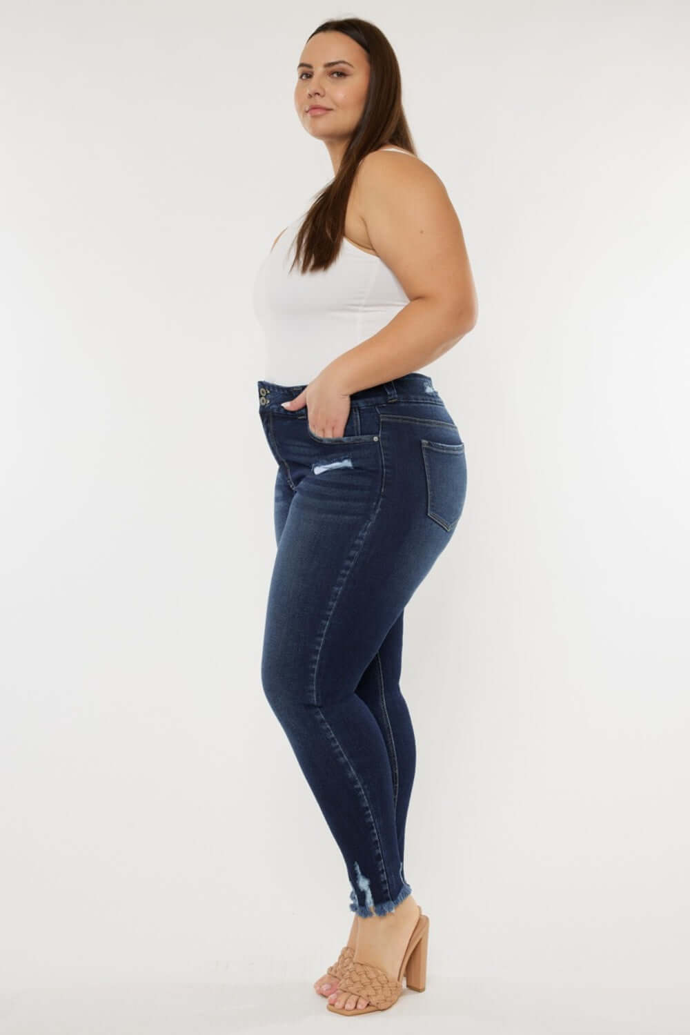 Model wearing Cat's Whiskers Raw Hem High Waist Jeans, showcasing the side view with raw hem detailing and a high waist fit.