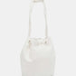 Nicole Lee USA Amy Studded Bucket Bag in white vegan leather with drawstring closure and metal feet, featuring a stunning stud and zipper design.