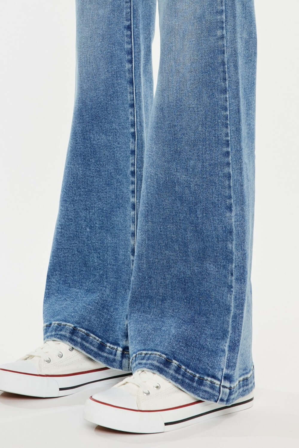 Kancan high-rise wide leg jeans in medium wash paired with sneakers, showcasing classic style and comfortable fit.