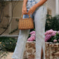 Bella Road side slit straight leg jeans in light wash, styled with a cute woven basket and surrounded by flowers.