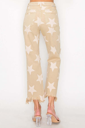 High rise jeans with star print and frayed hem, showcasing a chic and edgy style for a bold fashion statement.