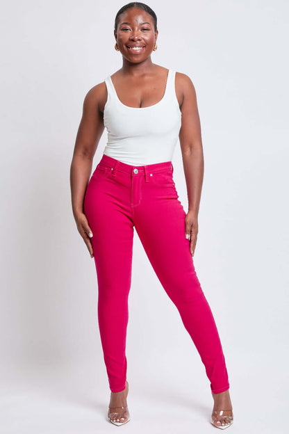 Woman wearing vibrant red Hyperstretch Mid-Rise Skinny Jeans by YMI Jeans, showing off a flattering and comfortable fit.