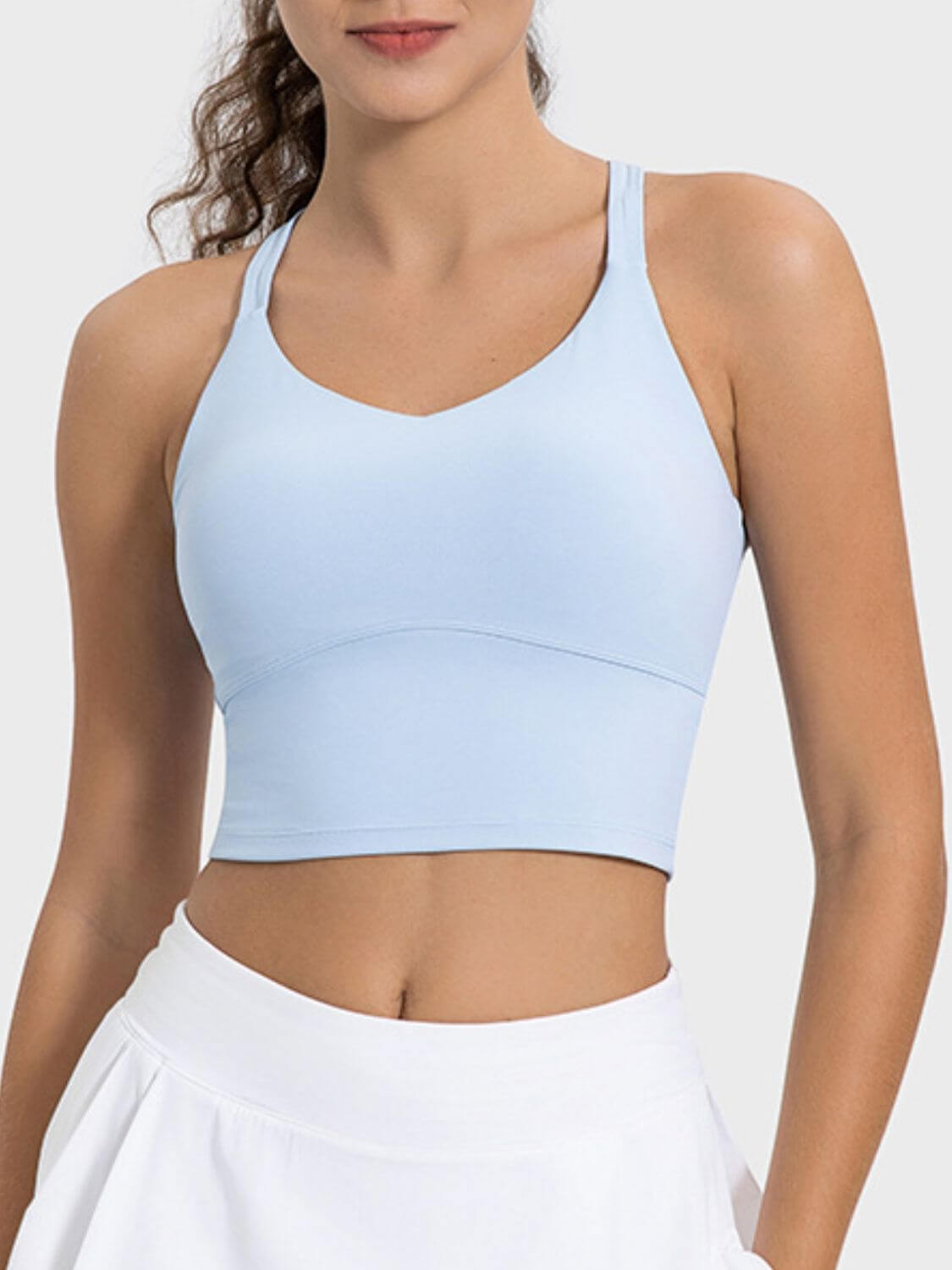 Light blue crisscross active tank top with a round neck, perfect for workouts and casual wear.