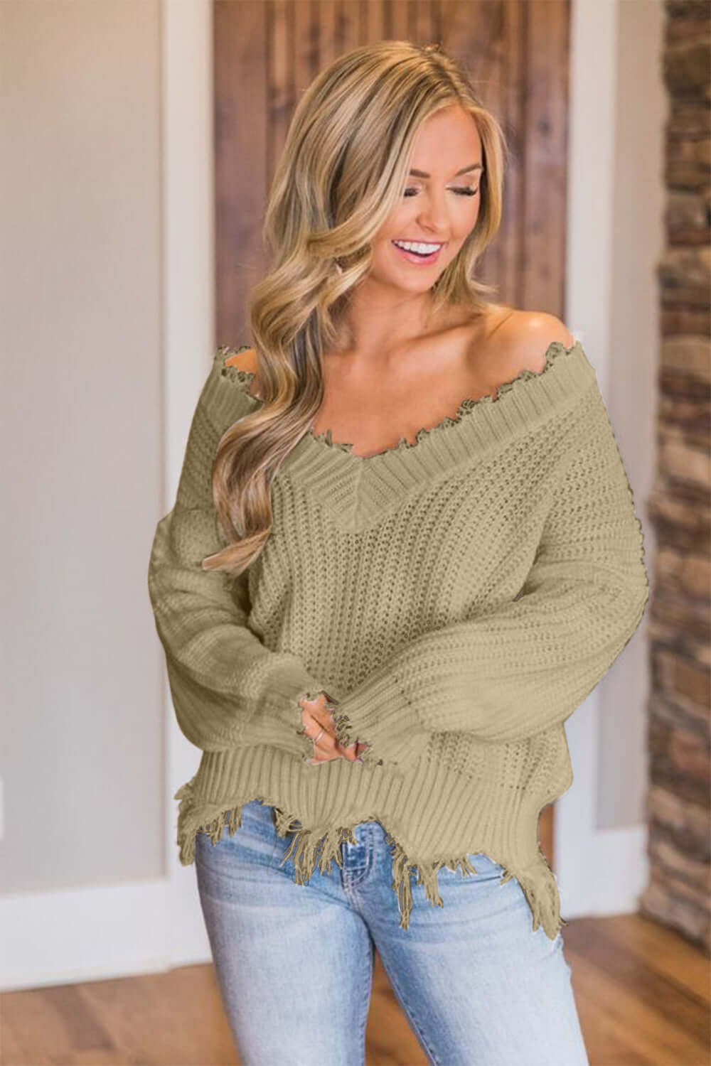 Woman wearing Bella Road Frayed Hem Dropped Shoulder Sweater, showcasing a playful and stylish look.