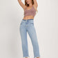 Woman wearing RISEN Full Size High Rise Raw Edge Crop Jeans with a raw hem, slightly stretchy denim, and a high-rise fit ending above the ankle.