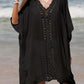 Woman wearing black cutout V-neck three-quarter sleeve cover up on a beach