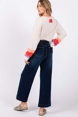 Woman wearing High Waist Wide Leg Jeans with a casual sweater, showing back pockets and relaxed wide leg style for comfort.