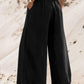 Model showcasing Bella Road Drawstring Wide Leg Jeans in black, featuring a trendy drawstring waist and spacious pockets.