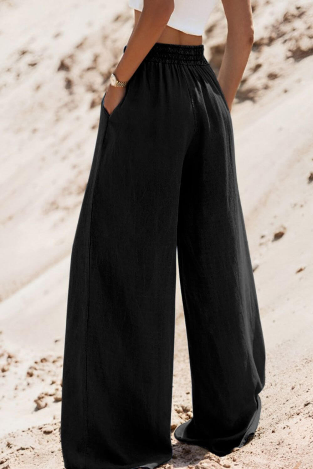 Model showcasing Bella Road Drawstring Wide Leg Jeans in black, featuring a trendy drawstring waist and spacious pockets.