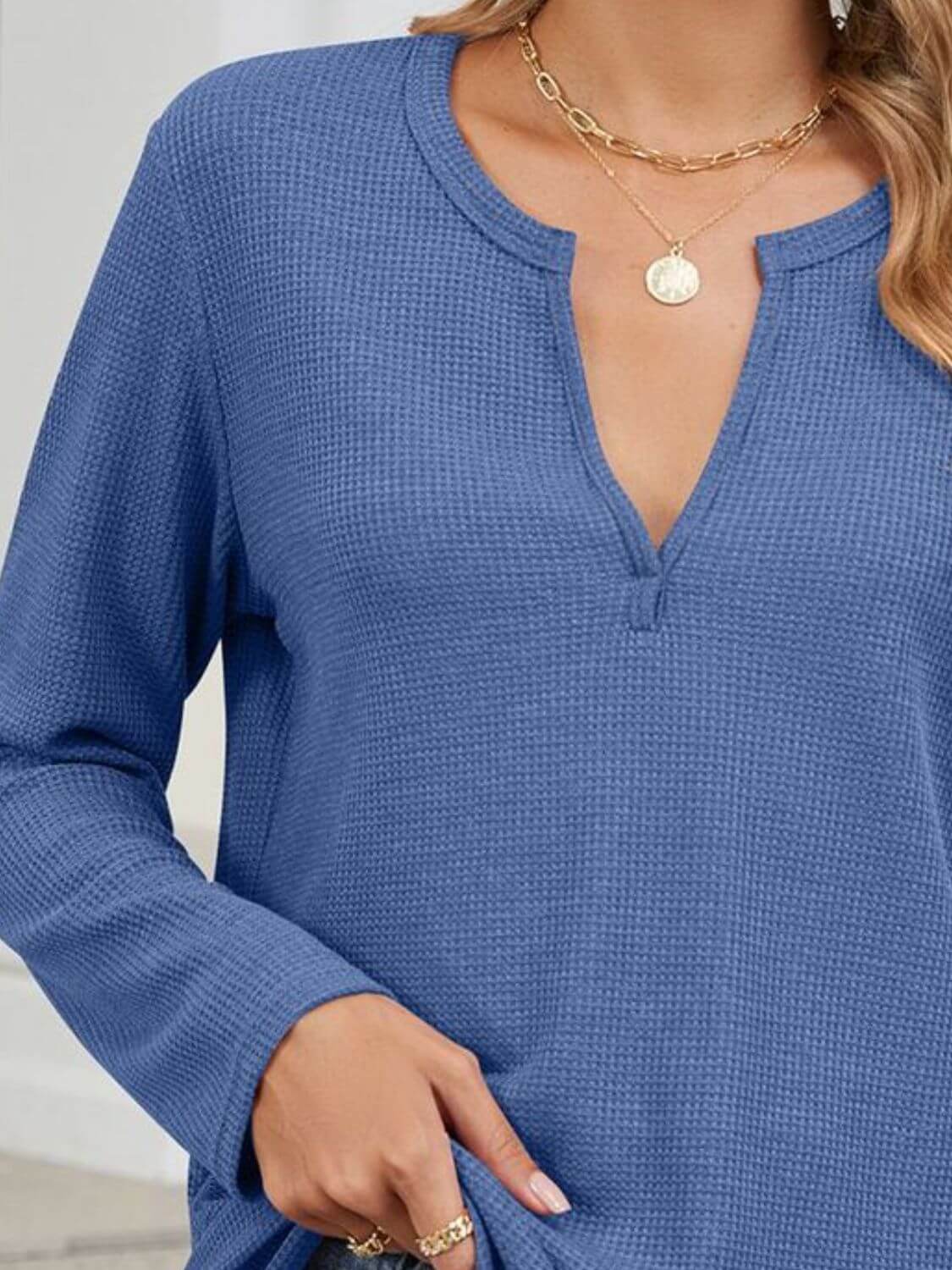 Woman wearing Bella Road blue waffle-knit notched long sleeve t-shirt with slight stretch and gold necklace.