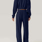 Back view of navy Bella Road Crisscross Round Neck Top and Drawstring Pants Set made of 100% polyester.