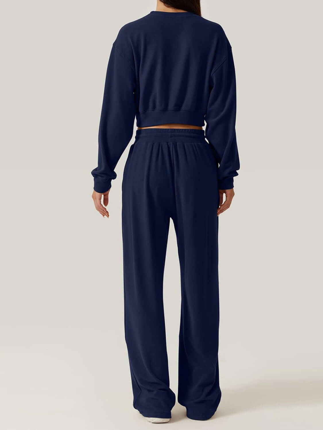 Back view of navy Bella Road Crisscross Round Neck Top and Drawstring Pants Set made of 100% polyester.