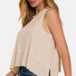 Woman wearing Exposed Seam Slit Round Neck Tank with jeans, showcasing modern and stylish design.