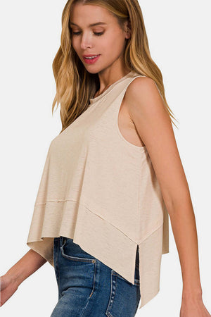 Woman wearing Exposed Seam Slit Round Neck Tank with jeans, showcasing modern and stylish design.