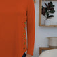 FAM-FAM round neck long sleeve t-shirt in orange with decorative side buttons, perfect for casual occasions and versatile style.