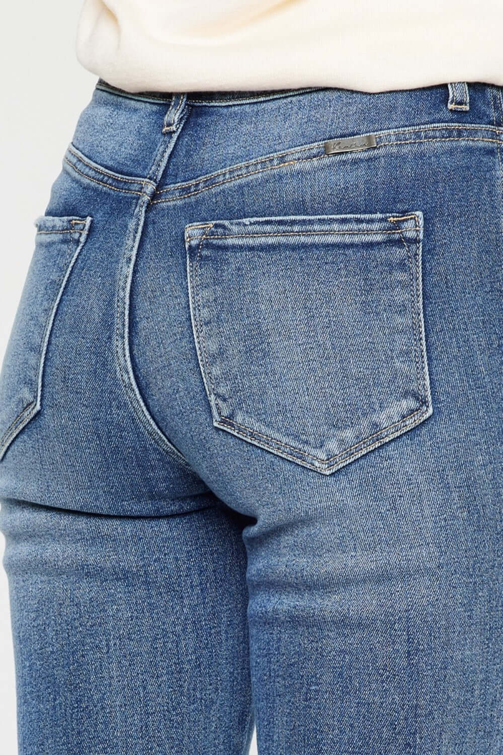 Close-up of back pocket and high waist design of Cat's Whiskers High Waist Flare Jeans in blue denim