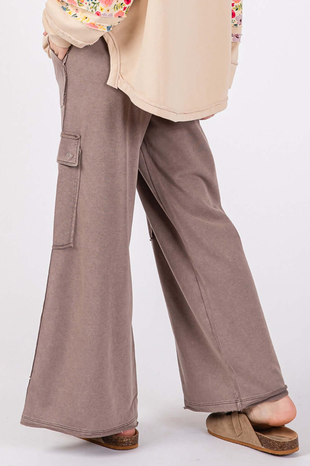 Wide leg knit terry mineral wash pants worn with a floral top and sandals