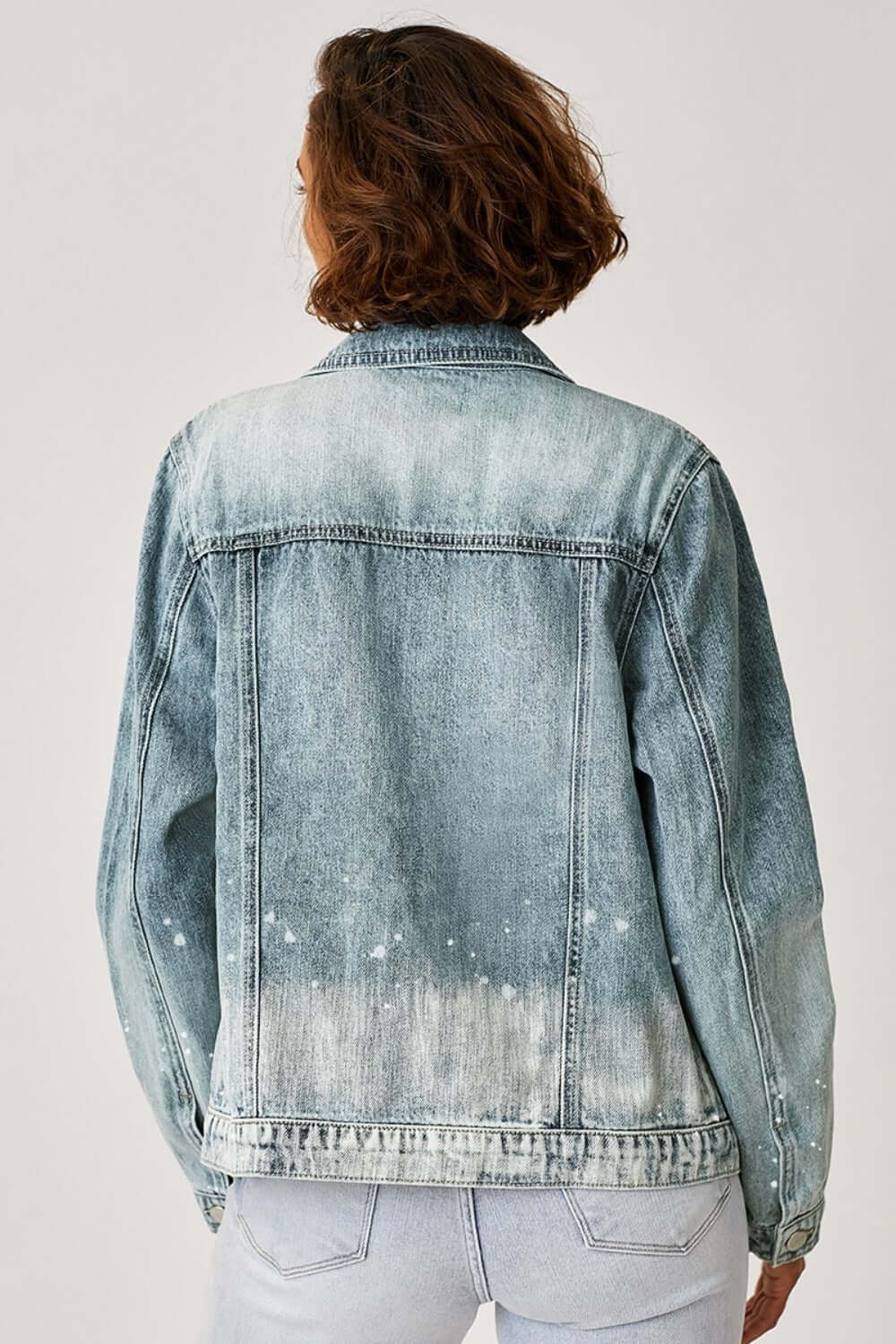 Back view of button-up ombre washed denim jacket by Risen Jeans, featuring a stylish gradient effect and casual, relaxed look.