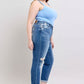 Judy Blue plus size button fly distressed jeans, showing stylish fit and practical pockets on a model in a blue tank top.