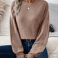 Woman wearing Bella Road Ribbed Round Neck Lantern Sleeve T-Shirt sitting on couch.