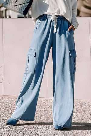 Light wash wide leg jeans with drawstring waist and cargo pockets, perfect for casual outings and staying stylish.