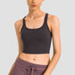 Sleek Millennia Racerback Sports Bra in black, offering comfort and style for yoga and fitness activities.