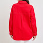 Back view of a woman wearing a red RISEN button-down long sleeve denim shacket, showcasing its stylish design and fit.