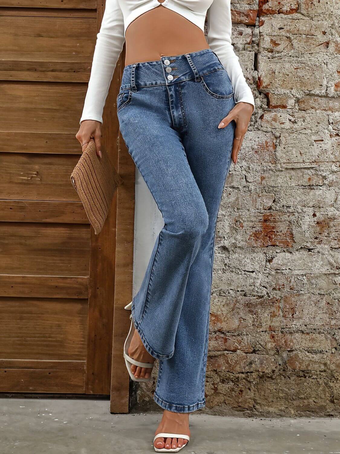 Stylish Bella Road Bootcut Jeans featuring pockets, medium wash, and a trendy buttoned design. Perfect for casual outings!