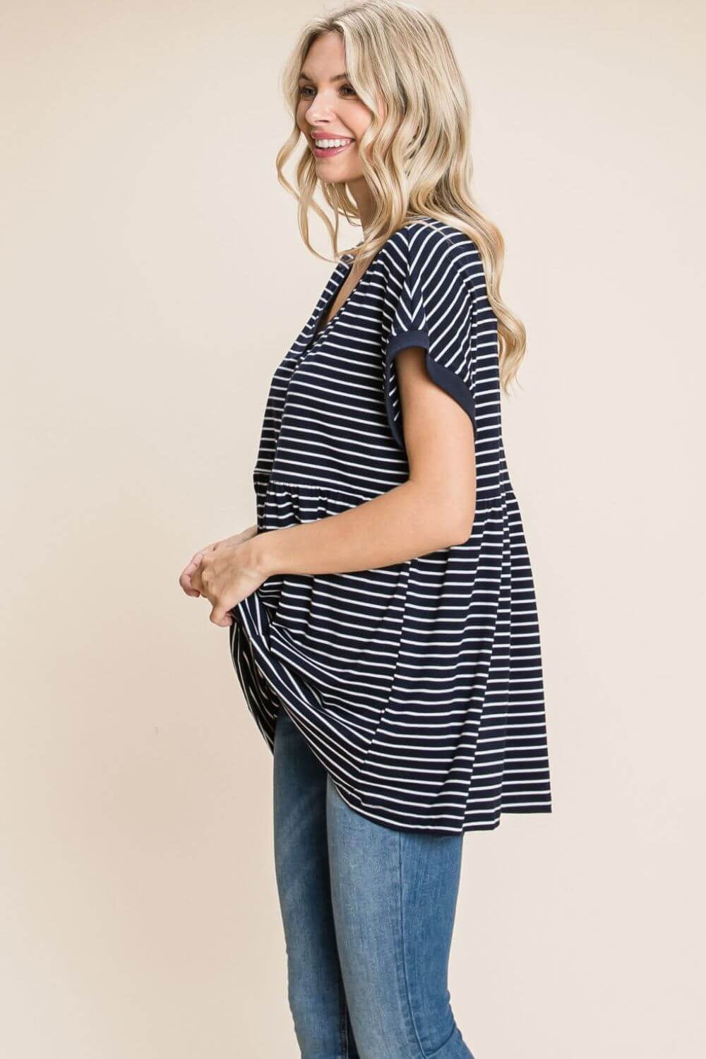 Woman wearing a Striped Button Front Baby Doll Top with blue jeans, showcasing the fitted bodice and lightly flared hem.