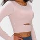 Millennia long sleeve cropped top in soft pink, featuring a stylish cutout and support strap for comfort and style.