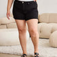 Woman wearing black tummy control high waist denim shorts from RFM Jeans in a chic and comfortable fit