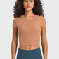 Millennia Round Neck Short Sleeve Cropped Sports T-Shirt in sandy color, perfect for yoga, featuring a stylish round neck.