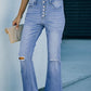 Woman wearing Bella Road Button-Fly Distressed Raw Hem Flare Jeans with a white top, showcasing buttoned and distressed details.