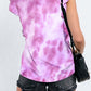 Woman wearing Bella Road Ruffled Printed T-Shirt with cap sleeves and tie-dye pattern, styled with black denim shorts.