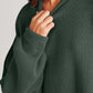 Woman wearing Double Take Side Slit Round Neck Long Sleeve Sweater in dark green.