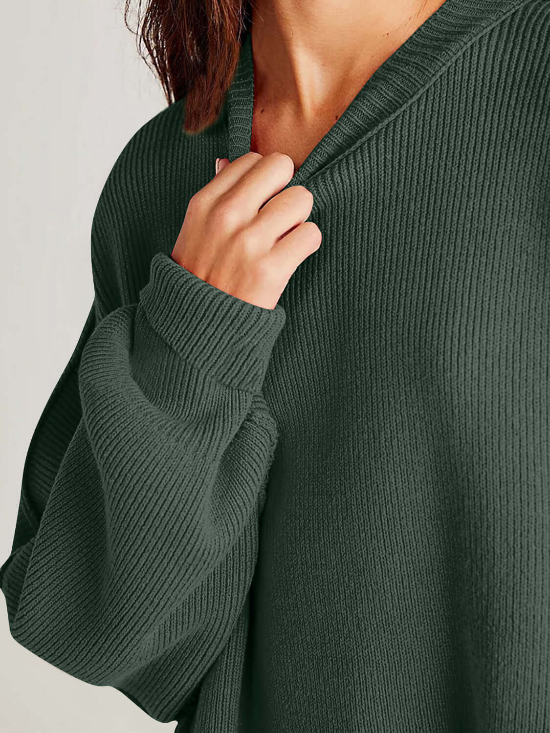 Woman wearing Double Take Side Slit Round Neck Long Sleeve Sweater in dark green.