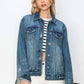 Stylish woman wearing a RISEN full-size distressed button-up jacket, featuring a vintage denim look and classic button closure.