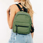 Stylish woman wearing a green adjustable strap nylon backpack, showcasing its lightweight and durable design.