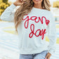 Woman wearing Bella Road Game Day Round Neck Long Sleeve Sweatshirt at the stadium