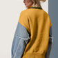 Trendy woman in a mustard yellow and denim raw edge sweater with a hat, showcasing unique fashion style from behind.