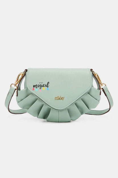 Light green Nicole Lee USA crossbody bag with pleated detailing and "Stay Magical" graphic on the flap.