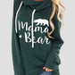 Woman wearing Bella Road green drawstring hoodie with "Mama Bear" graphic print, long sleeves, and slightly stretchy material.