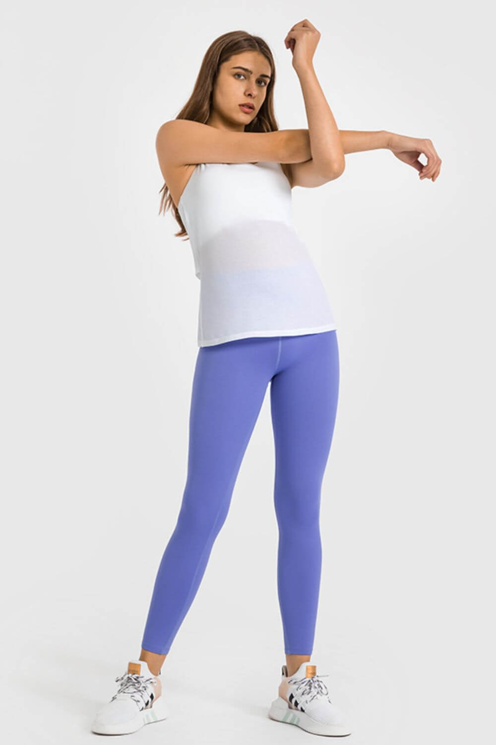 Stylish model in high waist ankle-length yoga leggings in vibrant purple, perfect for yoga and workouts.