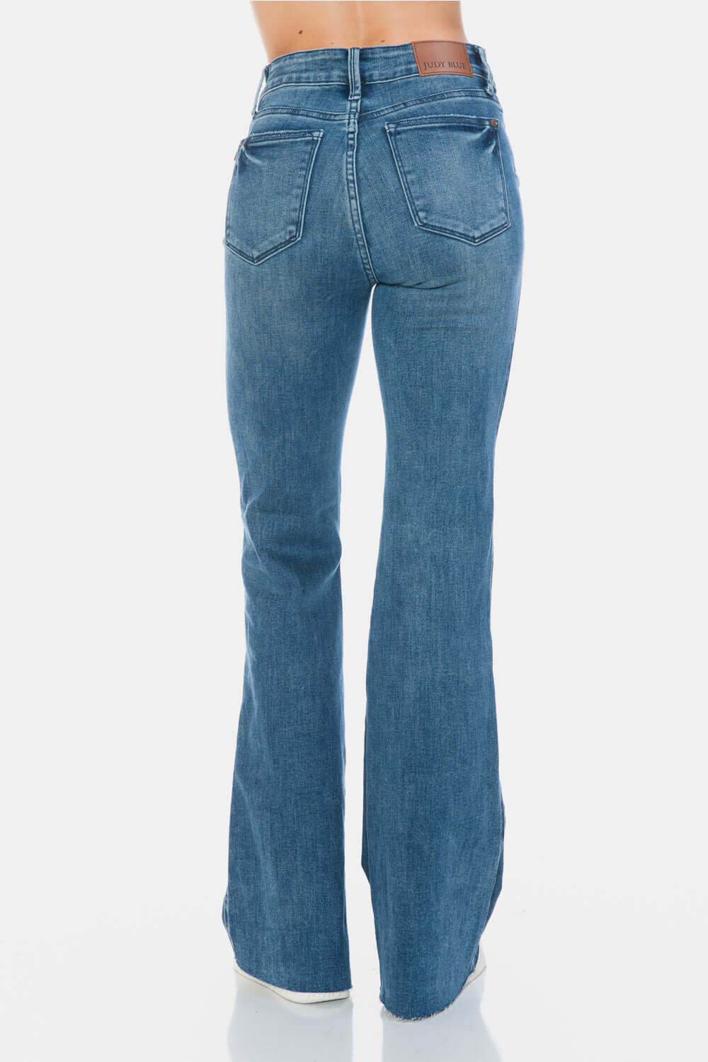 Judy Blue Full Size Tummy Control Cut Hem Flare Jeans back view, featuring vintage wash and modern cut hem for a flattering silhouette.