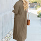 Woman wearing open front long sleeve cover up with pocket and sunglasses, showcasing lightweight outerwear, walking on a pathway