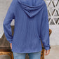 Woman wearing blue drawstring dropped shoulder long sleeve hoodie from the back.