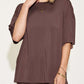 Woman wearing bamboo drop shoulder t-shirt and flare pants set in brown. Stylish two-piece outfit with stretchy, comfortable fit.